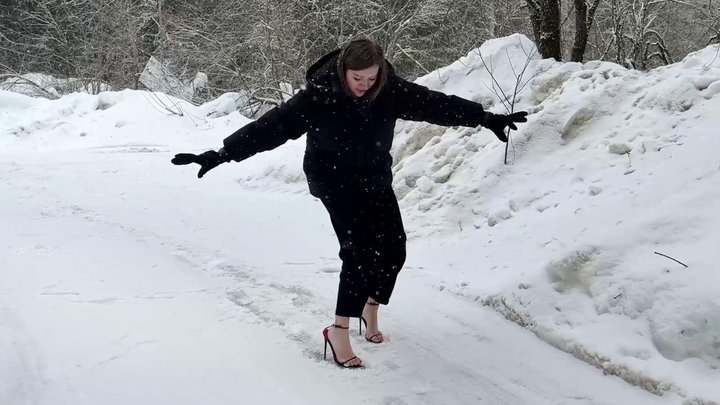 Girl on stilettos walking on ice, high heels on snow, high heels sliding, slippe