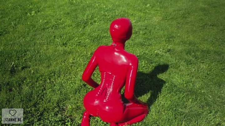 Red catsuit in green grass