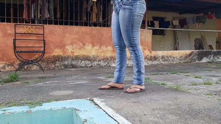 Woman desperate for chewing gum that sticks to her flip-flops while she tramples