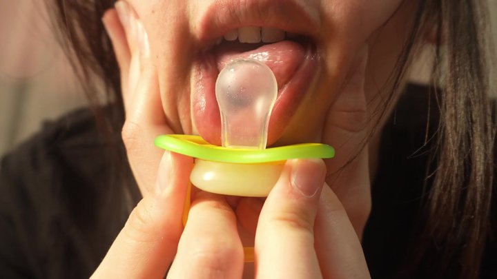 I find a pacifier and a piece of chewing gum under my pillow. I'm surprised by i