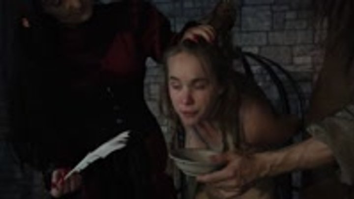 The vile witch girl is tied up and made to spit and drool by using a feather and