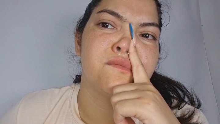 Sick girl makes her nose sniffle with mucus