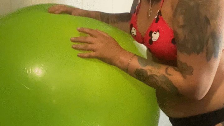 girl in swimsuit poping punchballoons in bathroom