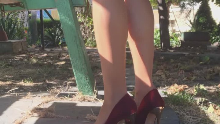 Red high heels in the garden
