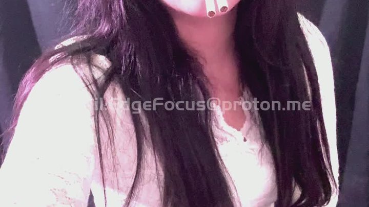The intelligent, beautiful woman quickly smoked two cigarettes in succession YAN