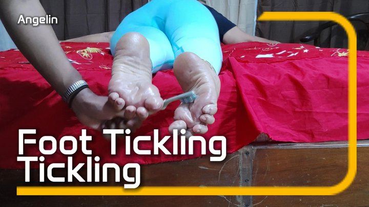 A woman lying face down and tied up is having her feet tickled (1)