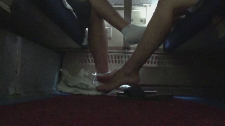 Playing with legs under the table on the train d