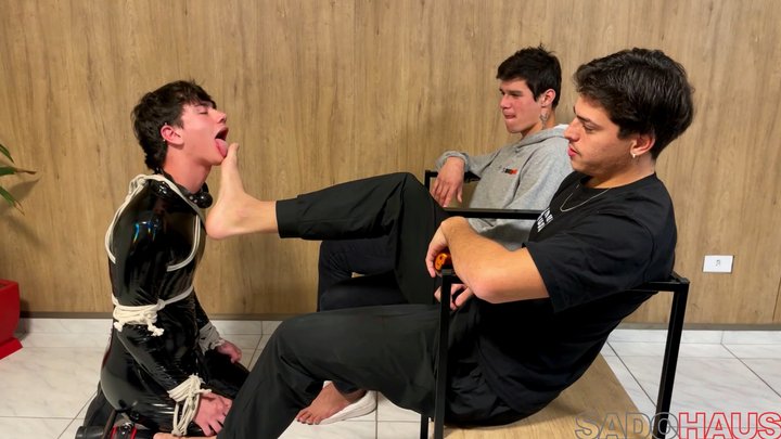 Humiliation & Servitude: Bound PVC Slave Serves The Feet, Ass & Dicks Of His Two