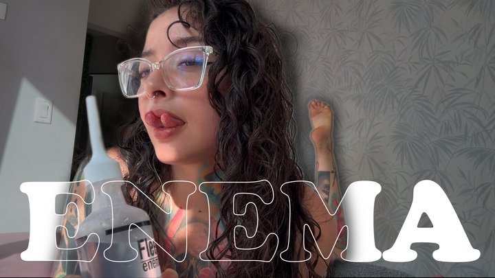 A girl with a split tongue gives herself an enema on camera.