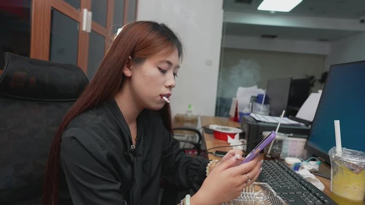 Chic Asian Woman Smoking Cigarette at Office Desk Nonstop Puffs — XIN3 4K