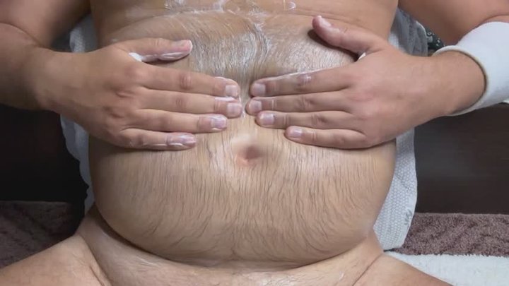massaging a fatty belly and rubbing in cream b