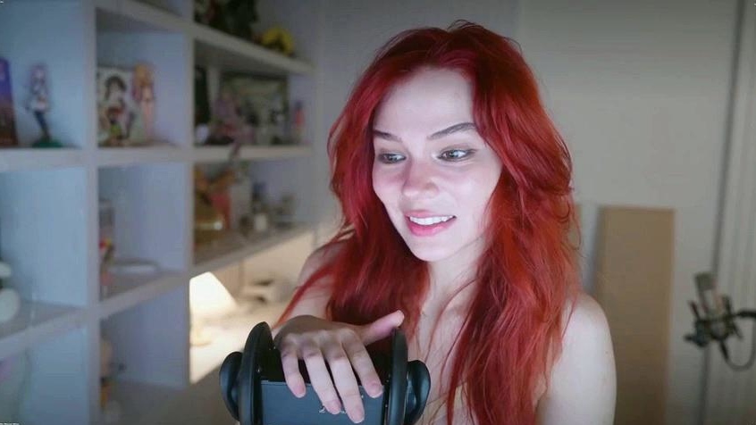 Redheaded pierced teen close up toy show