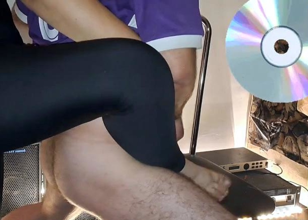 A mature woman in black leggings performs an intense ha